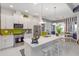 Modern kitchen with stainless steel appliances, white cabinets, and a large island at 2440 Pawtucket Pass, Mount Dora, FL 32757