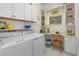 Functional laundry room featuring modern appliances, built-in shelves and ample counter space at 2440 Pawtucket Pass, Mount Dora, FL 32757