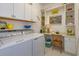 Well-lit laundry room featuring front loading machines, countertop space, and ample shelving at 2440 Pawtucket Pass, Mount Dora, FL 32757