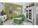 Cozy sitting area featuring green accents, ample natural light, and unique decor at 2440 Pawtucket Pass, Mount Dora, FL 32757