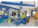Bright living room with colorful accents, a built-in entertainment center, and ample seating at 2440 Pawtucket Pass, Mount Dora, FL 32757