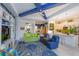 Open-concept living space with colorful furniture, tile flooring, and a modern kitchen at 2440 Pawtucket Pass, Mount Dora, FL 32757