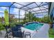 Outdoor pool and lounge area features a screened enclosure, inviting seating, and tranquil water view at 2440 Pawtucket Pass, Mount Dora, FL 32757