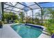 This screened pool features comfortable lounge seating and a lovely lake view, perfect for relaxation at 2440 Pawtucket Pass, Mount Dora, FL 32757