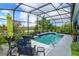 Beautiful screened-in pool area with lush landscaping, comfortable seating, and stunning water views at 2440 Pawtucket Pass, Mount Dora, FL 32757