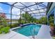 Beautiful screened pool area featuring a serene view, vibrant plants, and ample space for outdoor enjoyment at 2440 Pawtucket Pass, Mount Dora, FL 32757