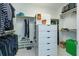 Well-organized walk-in closet with ample shelving, hanging space, and drawer storage at 2440 Pawtucket Pass, Mount Dora, FL 32757