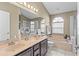 Well-lit bathroom featuring a soaking tub and dual sinks at 2737 Cahill Way, Lake Mary, FL 32746