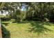 Enjoy the serenity of this backyard, showcasing mature trees and lush greenery, providing a private and tranquil setting at 3141 Cashmere Dr, Orlando, FL 32827