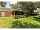 Backyard featuring a covered lanai, mature landscaping, and a lush green lawn, perfect for relaxation and outdoor activities at 3141 Cashmere Dr, Orlando, FL 32827