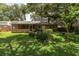 Beautiful backyard features a screened-in lanai, mature landscaping, and a lush green lawn, ideal for outdoor enjoyment at 3141 Cashmere Dr, Orlando, FL 32827