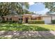 Charming single-story home features a lush green lawn and mature landscaping, creating inviting curb appeal at 3141 Cashmere Dr, Orlando, FL 32827