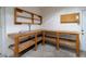 Workbench area with built in shelving and ample workspace in the garage at 3141 Cashmere Dr, Orlando, FL 32827