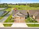 Aerial view of single-Gathering homes featuring manicured lawns, driveways, and serene neighborhood streets at 3279 Canna Lily Pl, Clermont, FL 34711