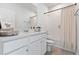 Bright bathroom featuring a white vanity, framed mirror, toilet, and a shower-tub combination with curtain at 3279 Canna Lily Pl, Clermont, FL 34711