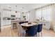 Bright, open dining room, kitchen combo, with white cabinetry, breakfast bar, and pendant lighting at 3279 Canna Lily Pl, Clermont, FL 34711