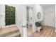 Inviting entryway with stairs, leading to a bathroom featuring stylish decor and a modern vanity at 3279 Canna Lily Pl, Clermont, FL 34711