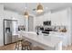 Elegant kitchen showcasing a center island with seating, pendant lights, and sleek stainless steel appliances at 3279 Canna Lily Pl, Clermont, FL 34711