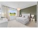 Inviting main bedroom with plush carpeting, decorative chandelier and a view of the outdoors at 3279 Canna Lily Pl, Clermont, FL 34711