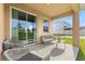 Relaxing covered patio with seating and view of the backyard at 3279 Canna Lily Pl, Clermont, FL 34711