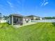 Well-maintained backyard featuring a patio, screened-in porch, lush grass, and a privacy fence at 3849 Kimbolton Way, Sanford, FL 32773