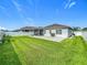 Backyard featuring a patio, grill, green grass, screened-in porch, and a white fence at 3849 Kimbolton Way, Sanford, FL 32773