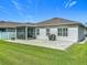 Backyard featuring a patio, grill, screened-in porch, green grass, and a white fence at 3849 Kimbolton Way, Sanford, FL 32773