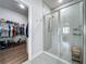 The modern bathroom includes a glass-enclosed shower and a well-organized walk-in closet at 3849 Kimbolton Way, Sanford, FL 32773