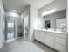 This stylish bathroom features dual vanity sinks, a large mirror, and a glass-enclosed shower at 3849 Kimbolton Way, Sanford, FL 32773