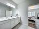 Bathroom boasts dual sinks and access to the bedroom with large bedroom window at 3849 Kimbolton Way, Sanford, FL 32773