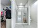 Bright and modern bathroom showcasing a glass-enclosed shower, and a view of the walk-in closet at 3849 Kimbolton Way, Sanford, FL 32773