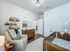 Charming Bedroom features a wooden crib, glider, and a changing table with ample storage at 3849 Kimbolton Way, Sanford, FL 32773