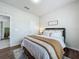 Cozy bedroom features hardwood floors, a shuttered window, stylish decor, and a comfortable bed at 3849 Kimbolton Way, Sanford, FL 32773