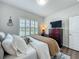 Cozy bedroom features wood floors, a shuttered window, a dresser with a TV, and a comfortable bed at 3849 Kimbolton Way, Sanford, FL 32773
