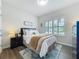 Inviting bedroom with shuttered windows, wood floors, stylish decor, and a comfortable bed at 3849 Kimbolton Way, Sanford, FL 32773