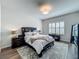 Bright bedroom features a queen bed with white linens and matching dark wood nightstands at 3849 Kimbolton Way, Sanford, FL 32773