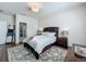 Cozy bedroom boasts a queen-size bed and ensuite bathroom with a rustic decorative ladder at 3849 Kimbolton Way, Sanford, FL 32773