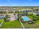 Aerial view of a community pool surrounded by lush landscaping and palm trees in a residential neighborhood at 3849 Kimbolton Way, Sanford, FL 32773