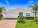 Charming single-story home with brick driveway, manicured lawn and meticulously designed tropical landscaping at 3849 Kimbolton Way, Sanford, FL 32773