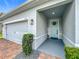 Inviting covered front entrance with brick accents and a stylish light blue door with a decorative wreath at 3849 Kimbolton Way, Sanford, FL 32773