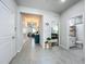 Bright hallway with tile flooring leading to bedrooms, bathrooms, and living areas, offering a spacious feel at 3849 Kimbolton Way, Sanford, FL 32773