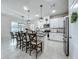 Well-equipped kitchen featuring a central island with seating, stainless steel appliances, and sleek white cabinets at 3849 Kimbolton Way, Sanford, FL 32773