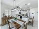 Charming eat-in kitchen boasts an island, granite countertops, stainless steel appliances, and white cabinetry at 3849 Kimbolton Way, Sanford, FL 32773