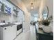 Bright laundry room featuring shelving, modern washer and dryer, and an open doorway to the rest of the home at 3849 Kimbolton Way, Sanford, FL 32773