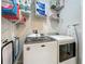 Laundry room featuring a modern washer and dryer, shelving, laundry supplies, and ironing board at 3849 Kimbolton Way, Sanford, FL 32773
