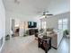 Bright living room features tile floors, a ceiling fan, a large sectional sofa, and a media console at 3849 Kimbolton Way, Sanford, FL 32773