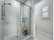 Modern shower featuring glass enclosure, tiled walls and a convenient bench for relaxation at 3849 Kimbolton Way, Sanford, FL 32773