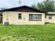 An exterior shot showcases the well-maintained backyard, surrounded by healthy green grass at 4394 Prince Hall Blvd, Orlando, FL 32811