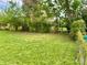 Spacious backyard with green lawn, mature trees, and room for outdoor activities at 4394 Prince Hall Blvd, Orlando, FL 32811