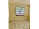 Modest bedroom featuring tile floors, window providing natural light and simple, neutral walls at 4394 Prince Hall Blvd, Orlando, FL 32811